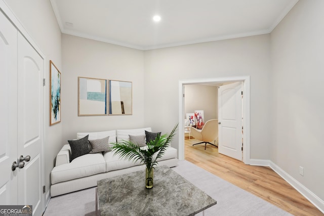 living room with crown molding, wood finished floors, and baseboards