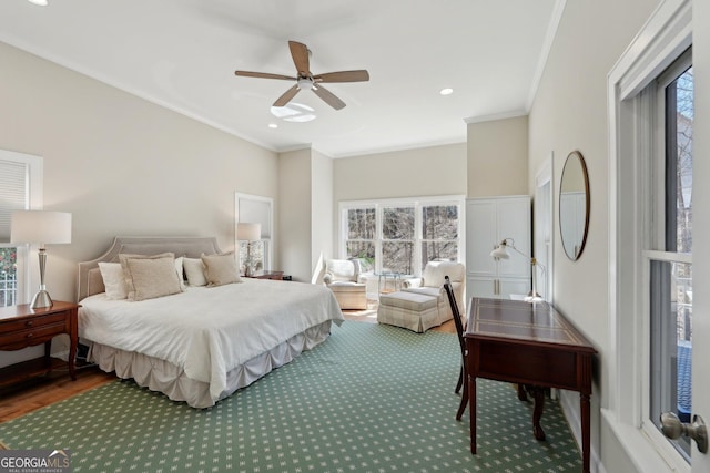 bedroom with ceiling fan, wood finished floors, and ornamental molding