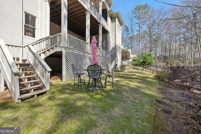 view of yard with stairway and fence