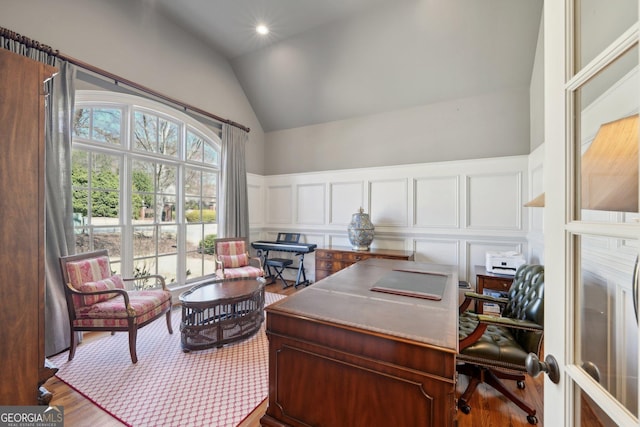 office featuring wood finished floors, recessed lighting, wainscoting, a decorative wall, and vaulted ceiling