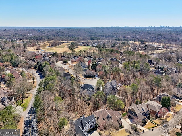 drone / aerial view featuring a forest view and a residential view