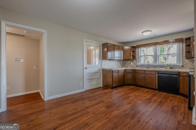 kitchen with dishwasher, open shelves, light countertops, and backsplash