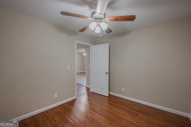 unfurnished room with baseboards, a ceiling fan, and wood finished floors