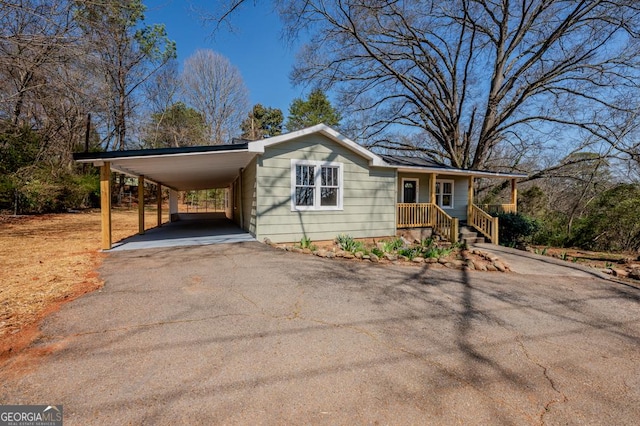 view of front of house with a carport and driveway