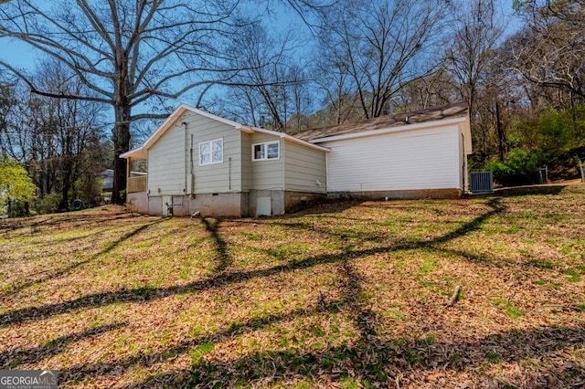 exterior space with cooling unit and a yard