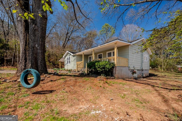 view of side of property with a porch