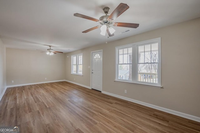 entrance foyer with visible vents, baseboards, a ceiling fan, and wood finished floors