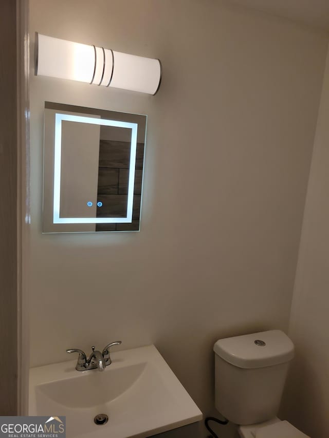 bathroom with toilet and vanity