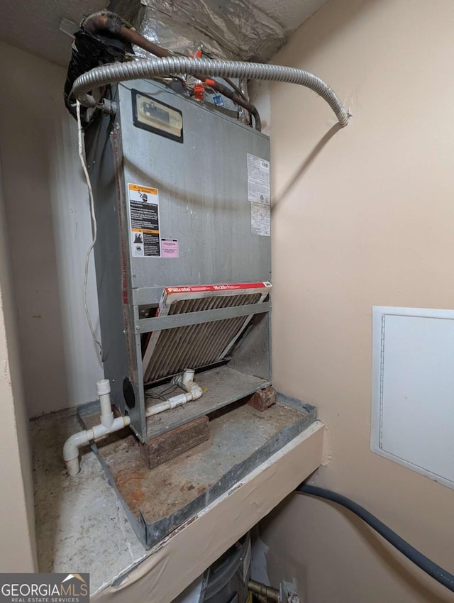 utility room with heating unit