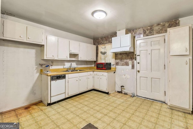 kitchen featuring light floors, dishwasher, light countertops, white cabinets, and a sink