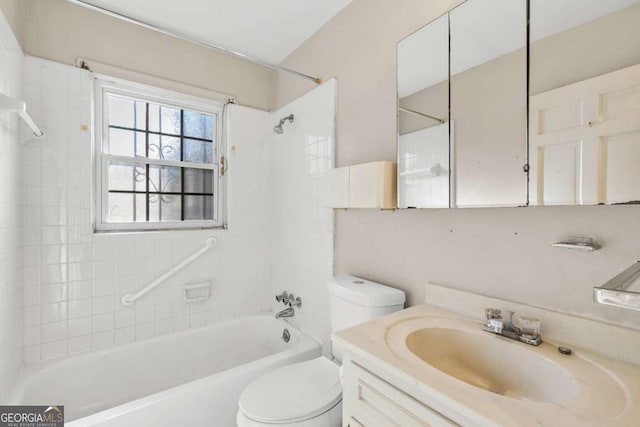 bathroom featuring vanity, toilet, and bathing tub / shower combination