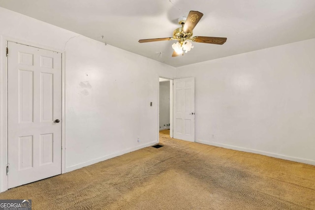 spare room featuring visible vents, baseboards, carpet floors, and ceiling fan