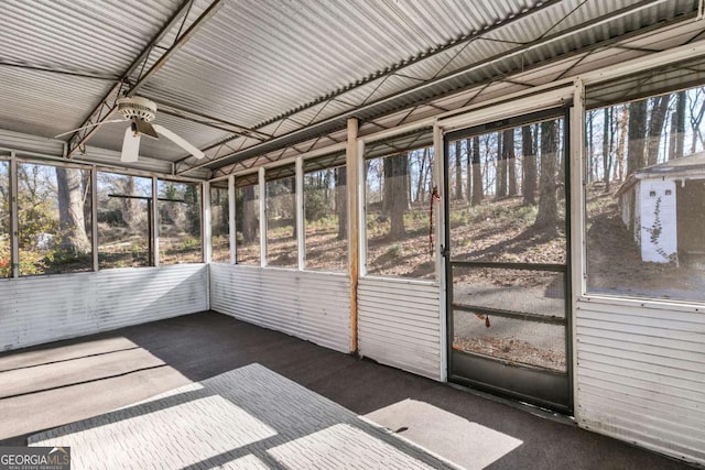 unfurnished sunroom with ceiling fan