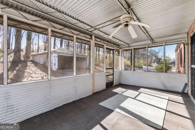 unfurnished sunroom featuring a ceiling fan