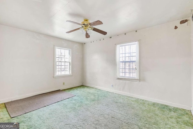 unfurnished room featuring baseboards, a healthy amount of sunlight, ceiling fan, and carpet flooring