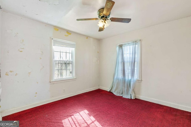 unfurnished room with baseboards, carpet floors, a healthy amount of sunlight, and ceiling fan