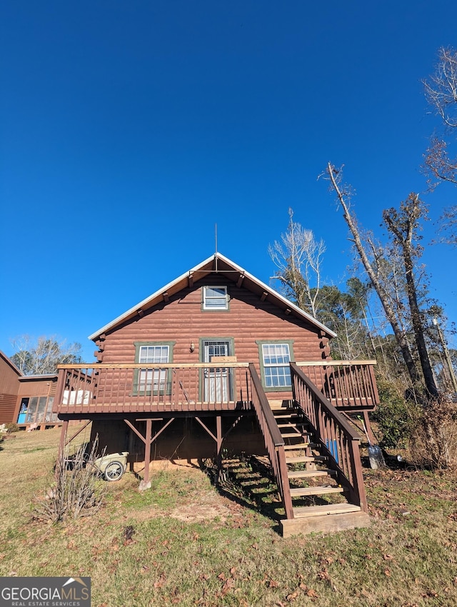 rear view of house featuring stairway and a wooden deck