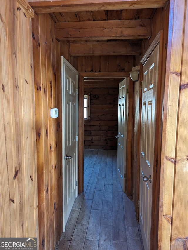 hallway featuring hardwood / wood-style flooring and wood walls