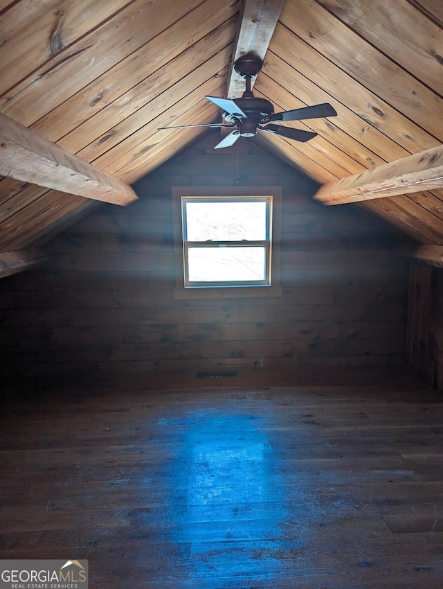 bonus room with dark wood finished floors, lofted ceiling with beams, a ceiling fan, and wooden ceiling