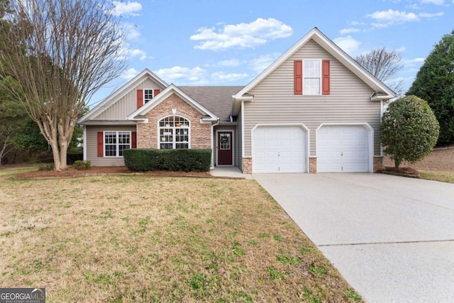 traditional-style home featuring concrete driveway, an attached garage, a front yard, and stone siding