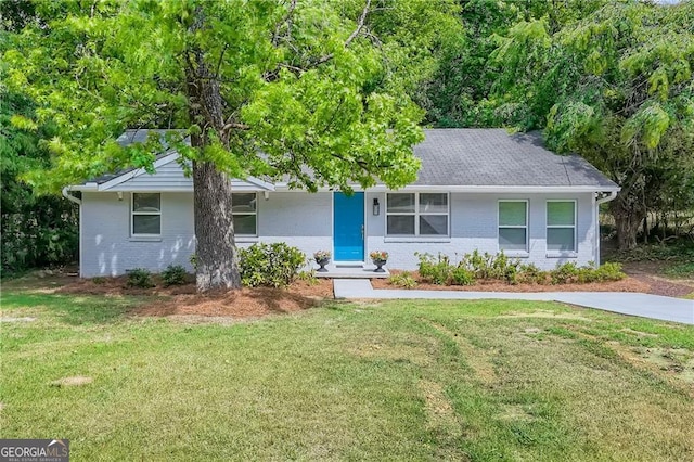 single story home with a front yard and brick siding