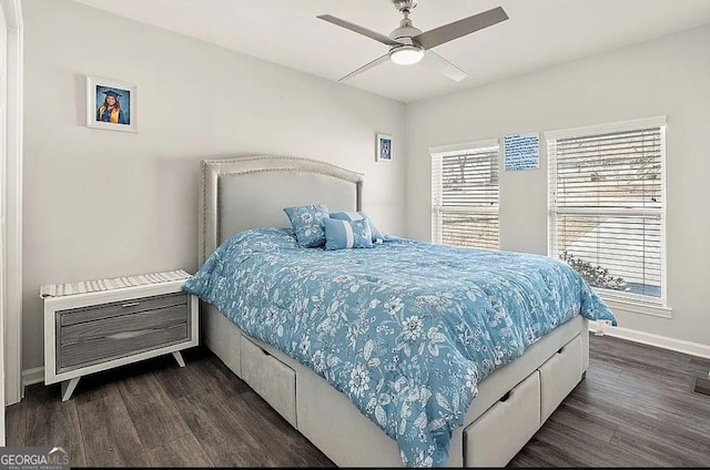 bedroom featuring dark wood-style floors, a ceiling fan, and baseboards