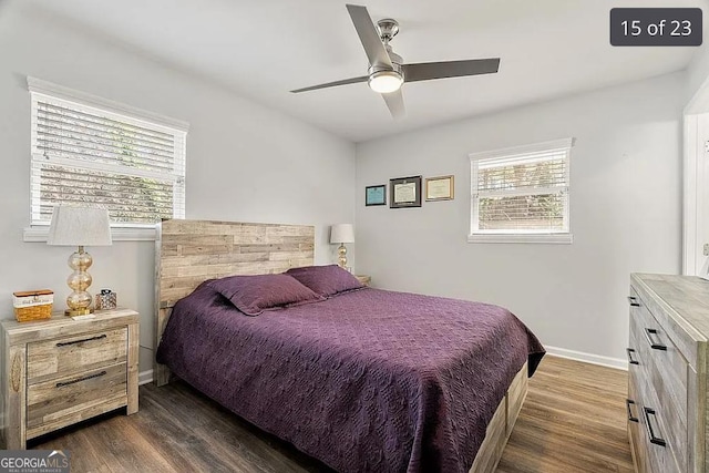 bedroom with dark wood-style floors, ceiling fan, and baseboards