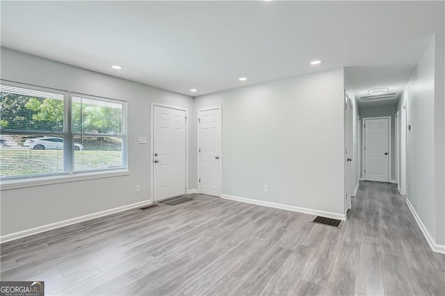 interior space featuring recessed lighting, light wood-style flooring, visible vents, and baseboards