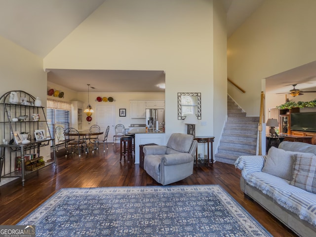 living room with stairway, high vaulted ceiling, ceiling fan, and hardwood / wood-style floors