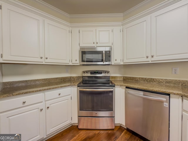 kitchen featuring white cabinetry, stainless steel appliances, dark wood-type flooring, and crown molding