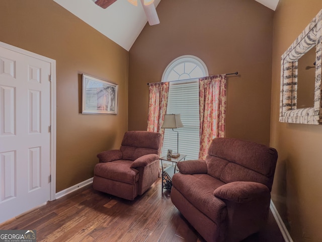 living area with ceiling fan, baseboards, high vaulted ceiling, and dark wood-style floors