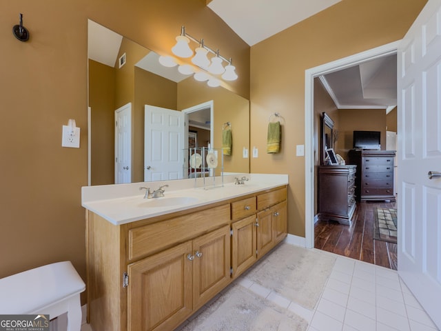 full bath with a sink, visible vents, double vanity, and tile patterned floors