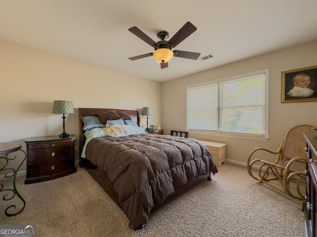 bedroom featuring visible vents, baseboards, a ceiling fan, and carpet flooring