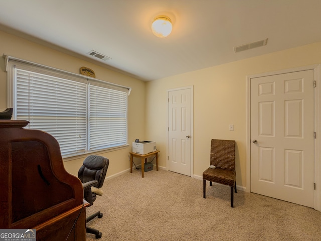 carpeted office with visible vents and baseboards