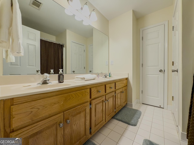 bathroom featuring visible vents, double vanity, a sink, curtained shower, and tile patterned floors