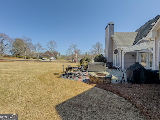 view of yard featuring a patio, a fire pit, and a pergola