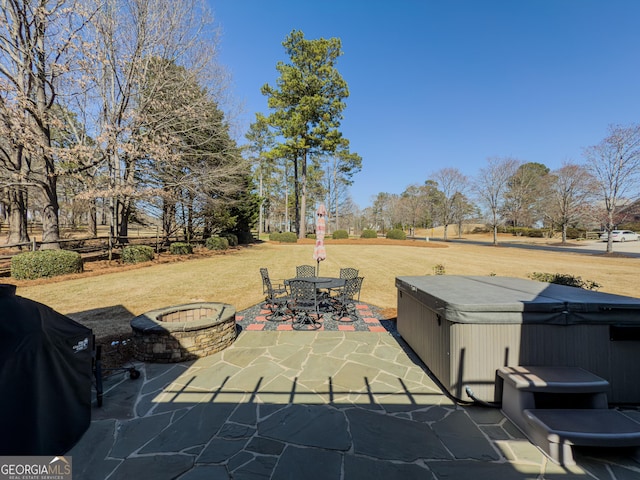 view of patio / terrace featuring area for grilling, outdoor dining space, and a hot tub