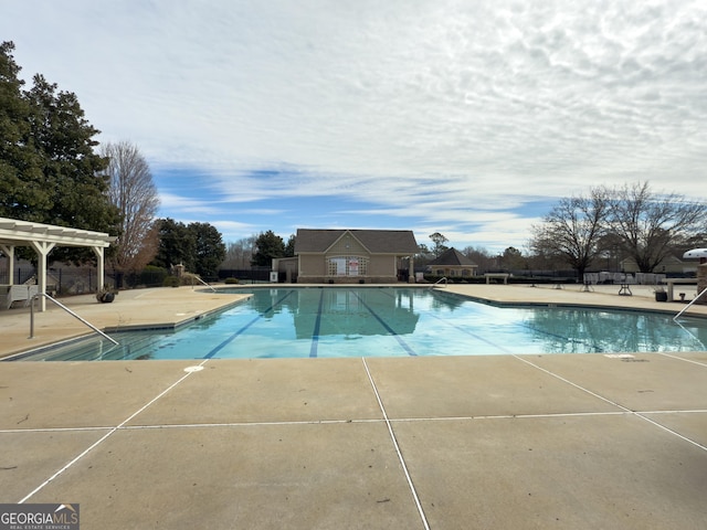 pool featuring a patio, fence, and a pergola