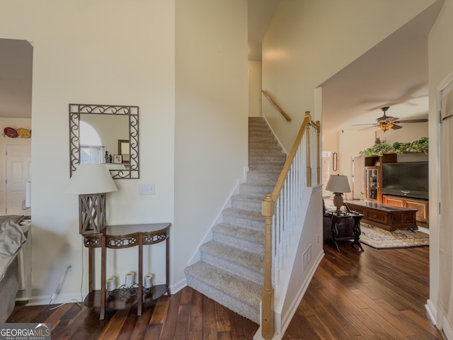 stairs with visible vents, baseboards, hardwood / wood-style floors, and a ceiling fan