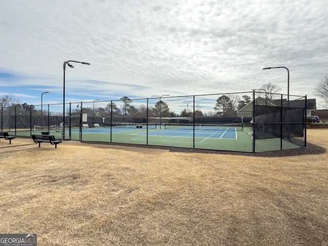 view of tennis court featuring fence