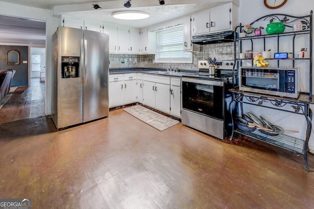 10174 Twin Oaks Dr SW, Covington, GA 30014 - kitchen with a sink, dark countertops, stainless steel appliances, under cabinet range hood, and tasteful backsplash