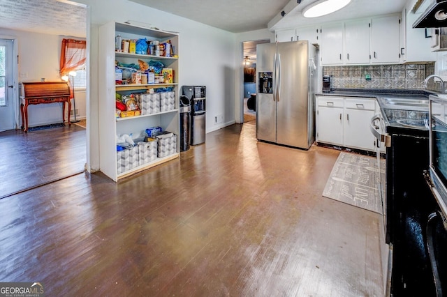 10174 Twin Oaks Dr SW, Covington, GA 30014 - kitchen with stainless steel refrigerator with ice dispenser, a sink, wood finished floors, and dark countertops