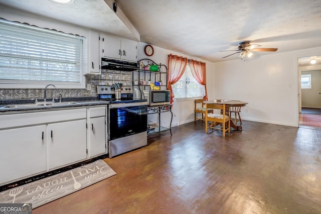 10174 Twin Oaks Dr SW, Covington, GA 30014 - kitchen with appliances with stainless steel finishes, a sink, extractor fan, dark countertops, and a ceiling fan