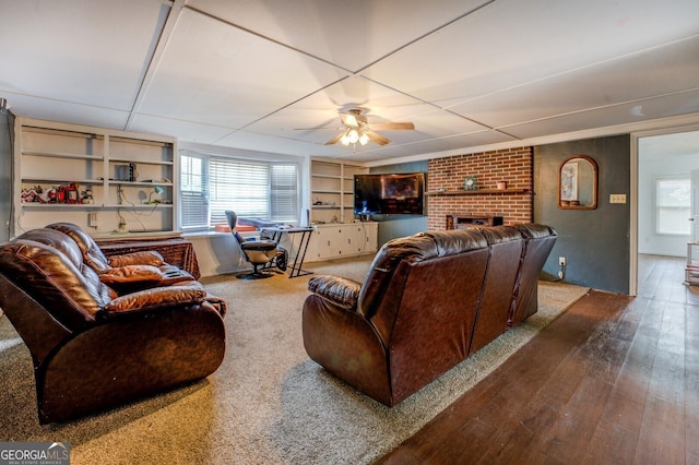 10174 Twin Oaks Dr SW, Covington, GA 30014 - living area featuring ceiling fan, a brick fireplace, plenty of natural light, and wood finished floors