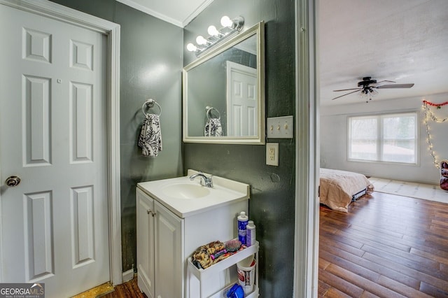 10174 Twin Oaks Dr SW, Covington, GA 30014 - bathroom with vanity, wood finished floors, a ceiling fan, and ornamental molding