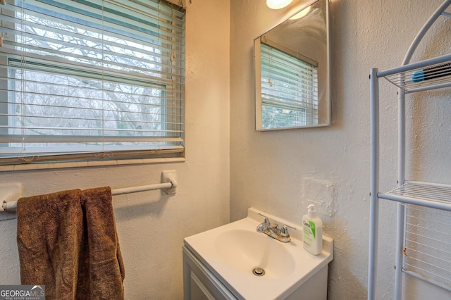 10174 Twin Oaks Dr SW, Covington, GA 30014 - bathroom with vanity and a textured wall