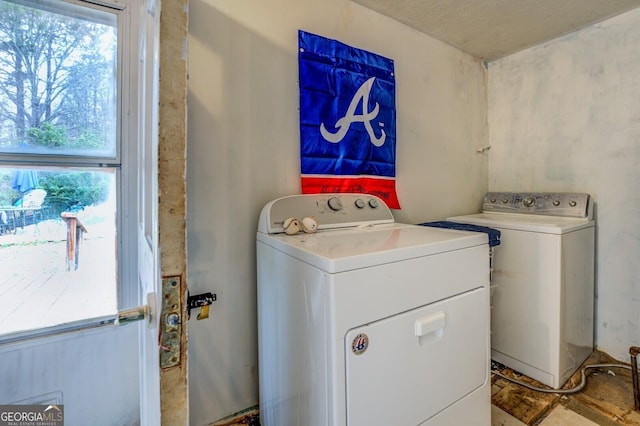 10174 Twin Oaks Dr SW, Covington, GA 30014 - laundry room with a wealth of natural light, separate washer and dryer, and laundry area