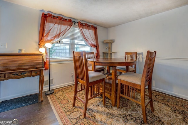 10174 Twin Oaks Dr SW, Covington, GA 30014 - dining room featuring baseboards and wood finished floors