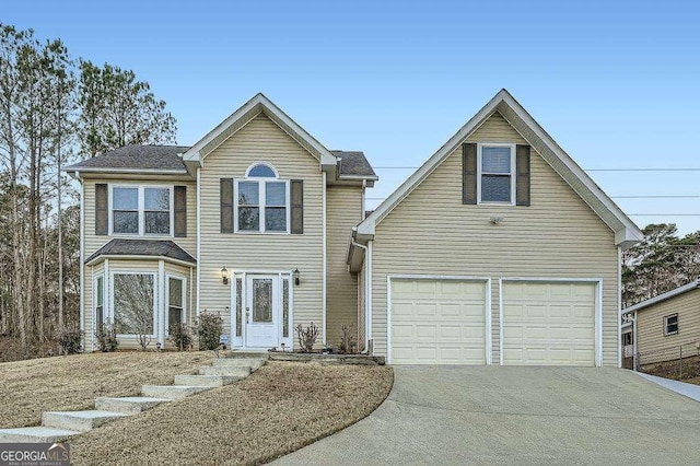 traditional-style home featuring a garage and driveway