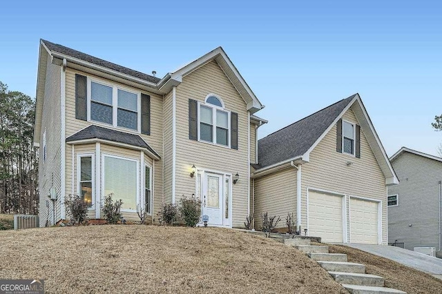 traditional home with central AC and driveway